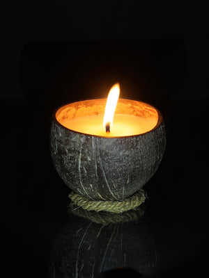 Coco Candle Co - small natural coconut shell soy candle burning at night